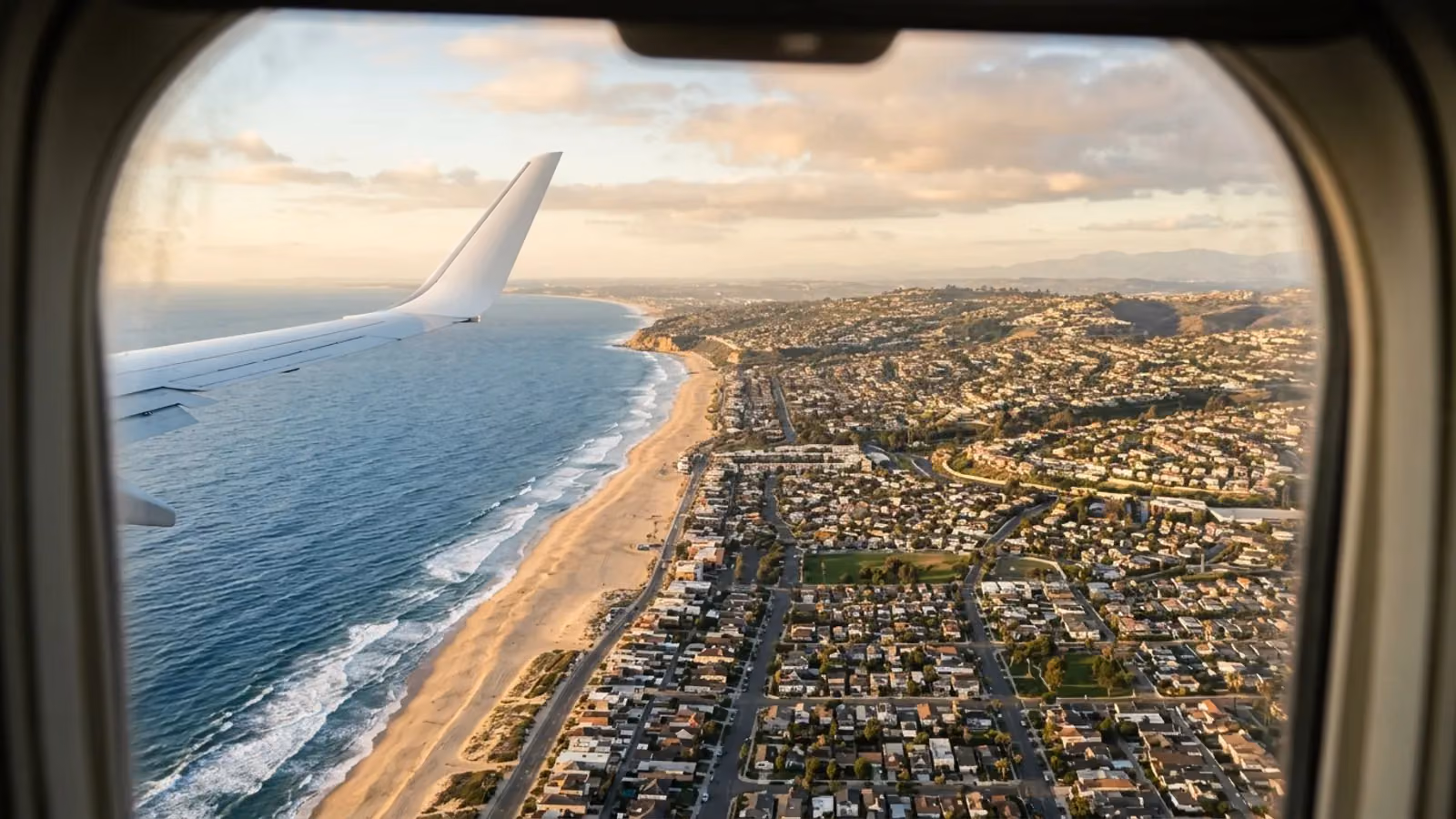 Coastline and suburbs seen from a window on approach