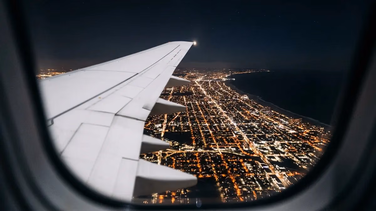 City grid lights from a window on a night departure