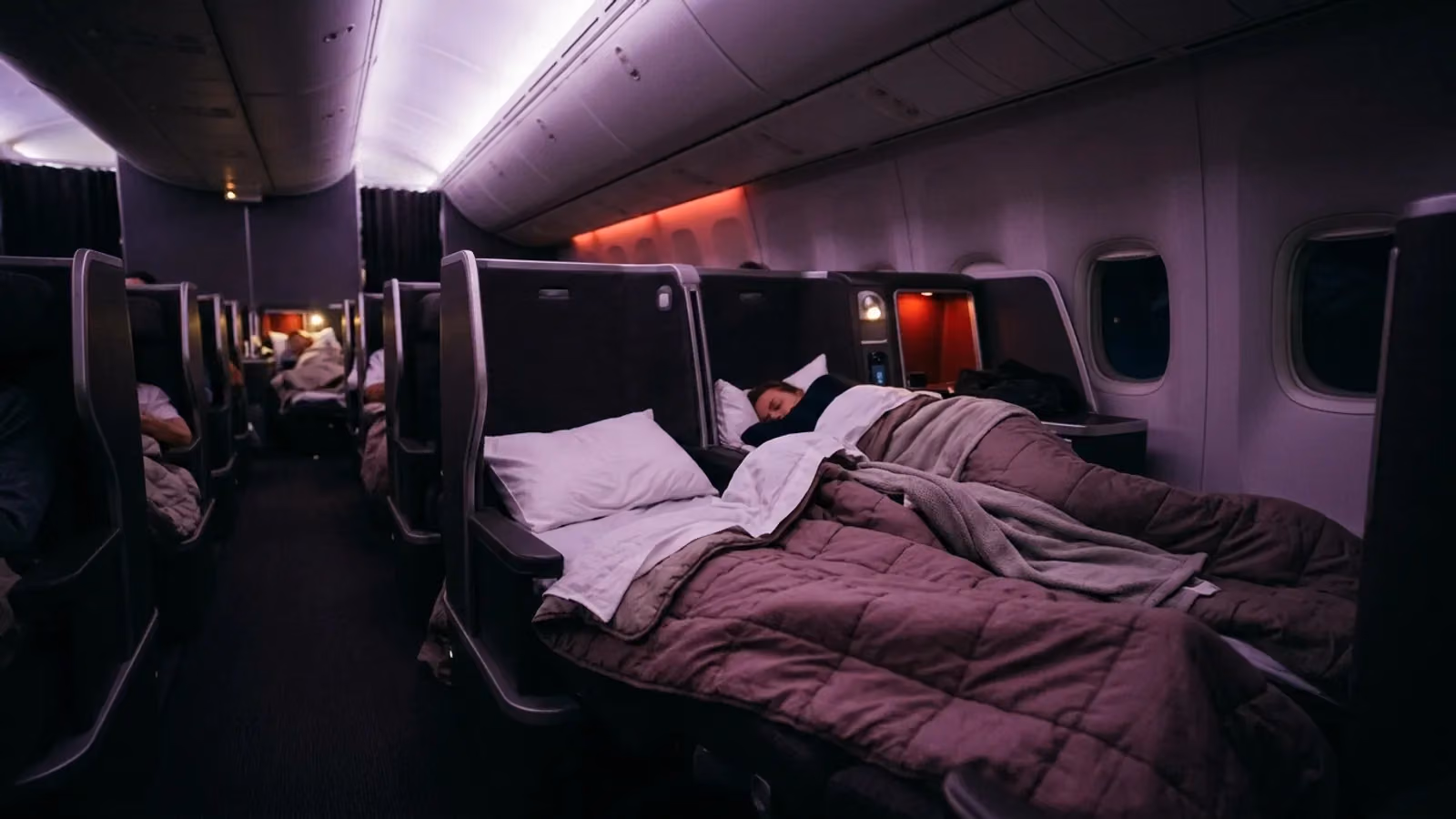 Business cabin at night with seats made into beds